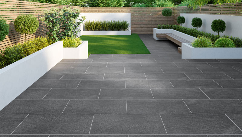 Expert tiler laying large format tiles in a modern bathroom